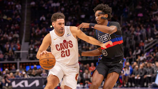 Dec 2, 2023; Detroit, Michigan, USA; Cleveland Cavaliers forward Georges Niang (20) moves the ball up court as Detroit Pistons forward Ausar Thompson (9) defends during the first half at Little Caesars Arena.